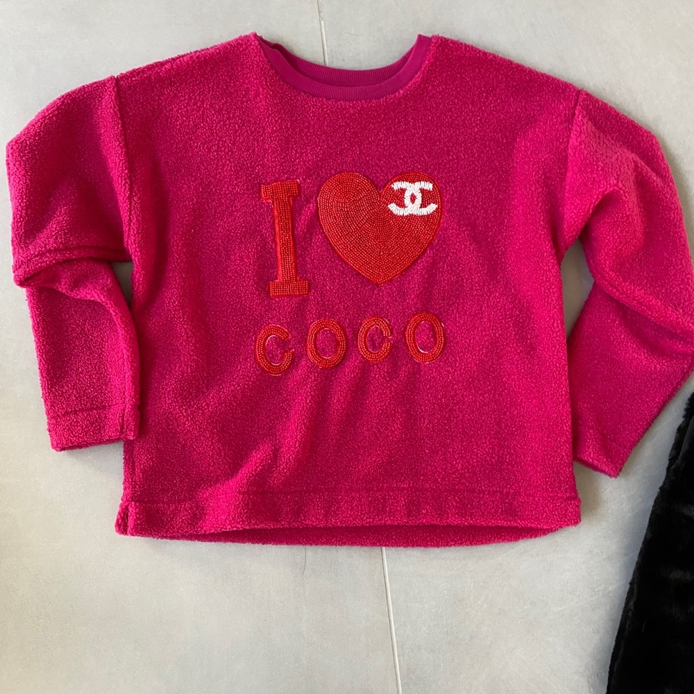 Pink sweatshirt with beaded sewn on appliqué